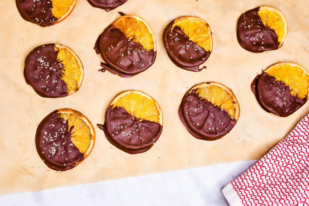 chocolate dipped oranges on baking sheet